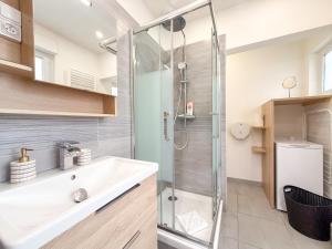 a bathroom with a shower and a sink at Les Volets Bleus in Chartres