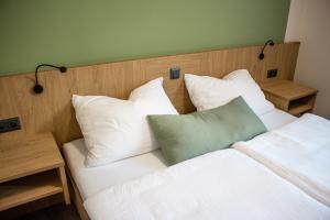 a bedroom with a bed with white pillows at Bärenhof in Matzen +2 photos