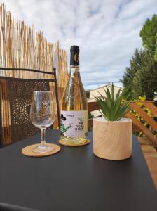 a bottle of wine and a glass on a table at O'me Wally in Galargues