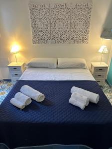 a bedroom with a bed with two white towels on it at CASA SOFIA in Anacapri +26 photos