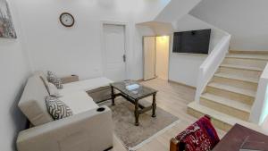 a living room with a couch and a tv at 325 · 2BR Townhouse 2 Bath TV in Sheikh Zayed