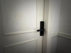 a white door with a black door knob on it at Suncrest Hotel # Self-check-in in Blackpool