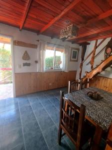 a dining room with a table and some windows at miradas serranas 2 in Villa Giardino +33 photos
