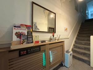 a bathroom with a sink and a mirror and stairs at Suncrest Hotel # Self-check-in in Blackpool