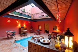 a large room with a swimming pool in a house at Le Jardin de Kabir in Martigny-Ville