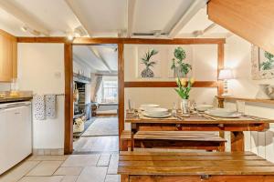 a kitchen with a wooden table with plates on it at 2 Bed in St. Minver oc-p27580 in Saint Minver