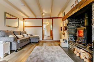 a living room with a couch and a fireplace at 2 Bed in St. Minver oc-p27580 in Saint Minver