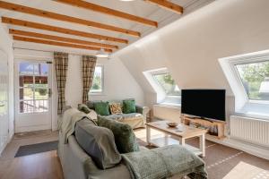 a living room with a couch and a tv at 2 Bed in Shipham oc-s31934 in Shipham