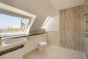 a bathroom with a sink and a toilet and a window at 2 Bed in Shipham oc-s31934 in Shipham +13 photos