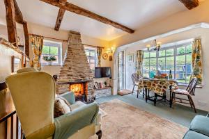 a living room with a fireplace and a dining room at 1 Bed in Duloe oc-b29367 in Duloe