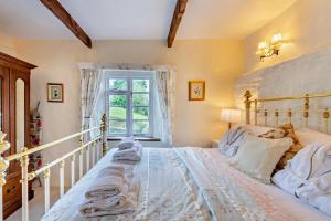a bedroom with a large white bed with a window at 1 Bed in Duloe oc-b29367 in Duloe