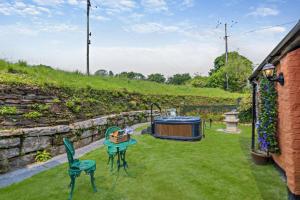 a garden with a table and chairs and a hot tub at 1 Bed in Duloe oc-b29367 in Duloe