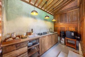 a kitchen with wood paneled walls and a counter top at Saughina Ubud in Ubud