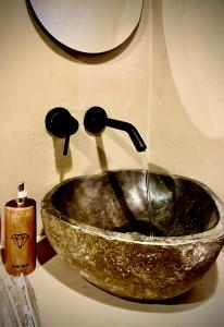 a bathroom sink with water coming out of it at Pinggan heaven in Gretek