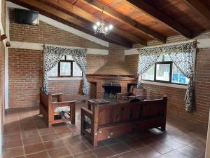 a room with a fireplace and a brick wall at La Casa del Abuelito in San Miguel Regla