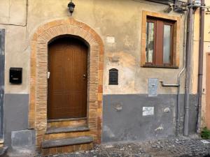 an entrance to a building with a wooden door at NEpicentro2 in Nepi +18 photos