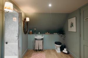 a bathroom with a sink and a toilet at Muir Cottage in Aboyne +4 photos