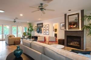 a living room with a couch and a fireplace at Maison du Soleil in Palm Springs