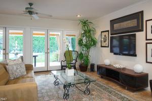 a living room with a couch and a coffee table at Maison du Soleil in Palm Springs