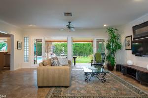 a living room with a couch and a table at Maison du Soleil in Palm Springs +42 photos