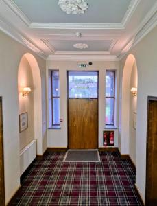a hallway with a wooden door in a building at Woodside House in Aberdeen +12 photos