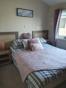 a bedroom with a large bed with pillows at Jasper Lodge in Morecambe +39 photos
