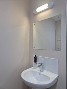 a bathroom with a white sink and a mirror at Woodside House in Aberdeen