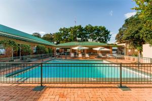 a swimming pool with a fence around it at Victoria Falls Premier Lodge in Victoria Falls
