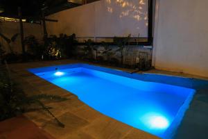a swimming pool with blue lighting in a room at Le Casa Villa by hotel travel inn in Pokhara
