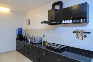 a kitchen with a black counter top with aounter at Le Casa Villa by hotel travel inn in Pokhara