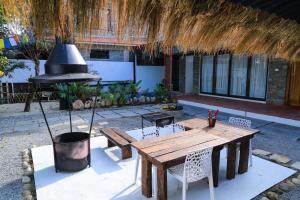 a wooden table and chairs in a patio at Le Casa Villa by hotel travel inn in Pokhara