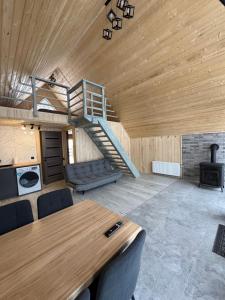 a room with a table and a spiral staircase at Dukaty House 2 in Verkhovyna