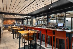a restaurant with tables and chairs and a bar at 3033 Suncadia Riverfront Studio Lodge Pool Access in Cle Elum