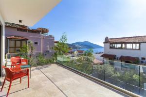 an apartment patio with a view of the water at Villa Gunes in Kalkan