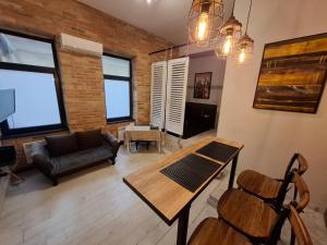 a living room with a table and a couch at Révay 6 Suites by Corall in Budapest
