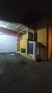 an empty garage with a building with a garage door at Happy Corner in Varaždin