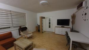 a living room with a couch and a flat screen tv at Happy Corner in Varaždin