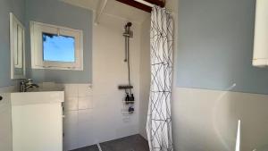 a bathroom with a shower and a sink at MarketHome Ecolodge Plataneras 2 in Chío +9 photos