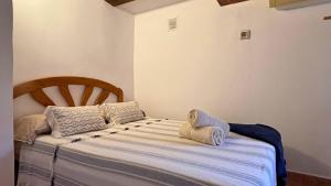 a bed with two pillows on it in a room at MarketHome Ecolodge Plataneras 2 in Chío