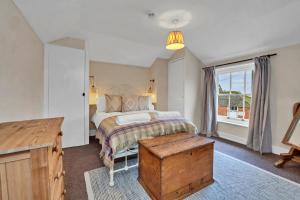 a bedroom with a bed and a large window at Finest Retreats - Clavering Hall in Saffron Walden