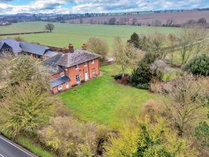 an aerial view of a large brick house on a field at Finest Retreats - Clavering Hall in Saffron Walden