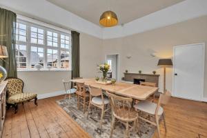 a dining room with a wooden table and chairs at Finest Retreats - Clavering Hall in Saffron Walden