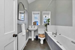 a white bathroom with a toilet and a sink at Finest Retreats - Clavering Hall in Saffron Walden +31 photos