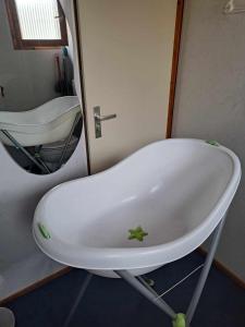 a bath tub sitting in front of a mirror at La Boverie, chalet 216 in Rendeux +37 photos