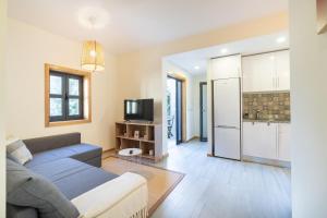 a living room with a couch and a kitchen at Sunset Apartments in Ovar