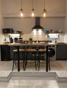 a kitchen with a table with chairs and a stove at Révay 6 Suites by Corall in Budapest