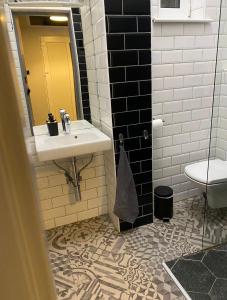 a bathroom with a sink and a toilet at Révay 6 Suites by Corall in Budapest +25 photos