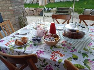 a table with a table cloth with food on it at Casa dei Colli in Monzambano