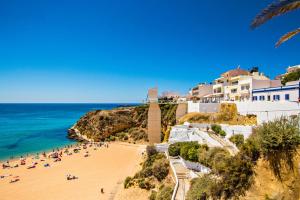 a group of people on a beach near the ocean at Sunny Condo-Pool by Algarve Dream Holidays in Albufeira