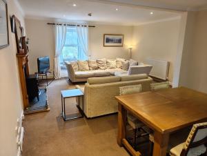 a living room with a couch and a table at Fintry Inn in Fintry